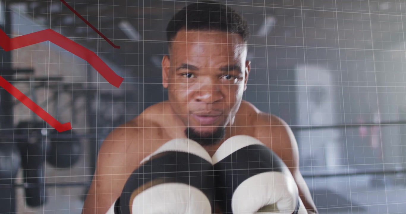 Male boxer jabbing forward and activating red graph and grid overlay in fitness ring tracking data