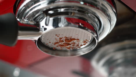 espresso droplets squeezed through bottomless portafilter basket in slow motion and macro