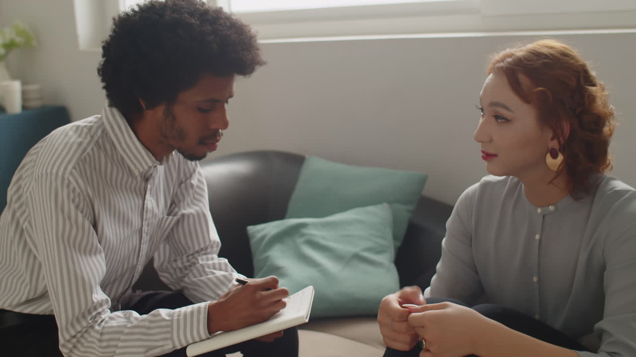 Male Therapist Supporting Female Patient at Therapy Session