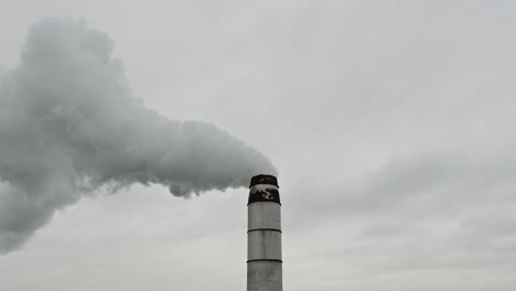 harmful greenhouse gases emitted by factory smokestack polluting the air