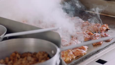 steaming food cooking on griddle in daytime kitchen