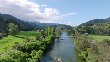 drone flying over the motueka river towards a river on a sunny day in new zealand