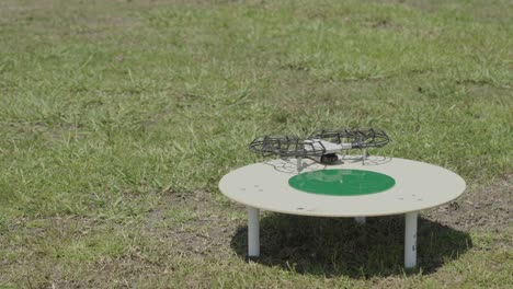 experience the seamless blend of technology and nature with this mesmerizing footage of a drone executing a precise landing on a designated pad in an expansive field