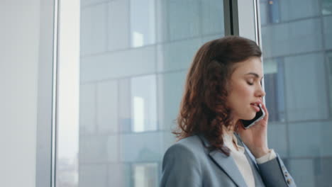 girl business manager calling client noting information in notepad close up.