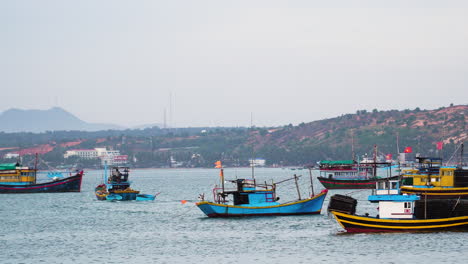 colorful vibrant boats of fishermen moored near coastline of vietnam