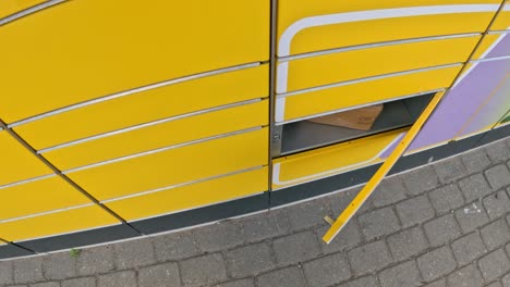 opening yellow parcel machine door, pov