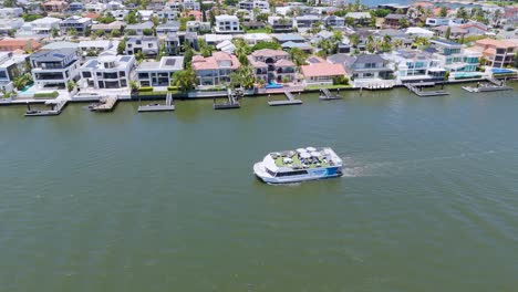 ferry cruising past waterfront homes in gold coast