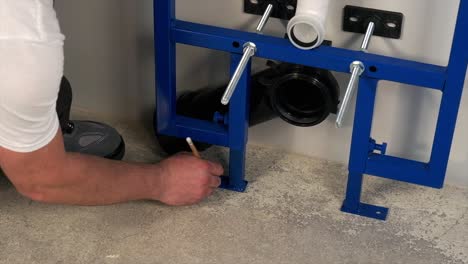 the worker who repairs and installs the toilet bowl and flush uses tools such as pliers and spanners