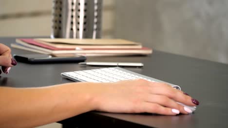 woman working in home office hand on keyboard. green screen mock-up display