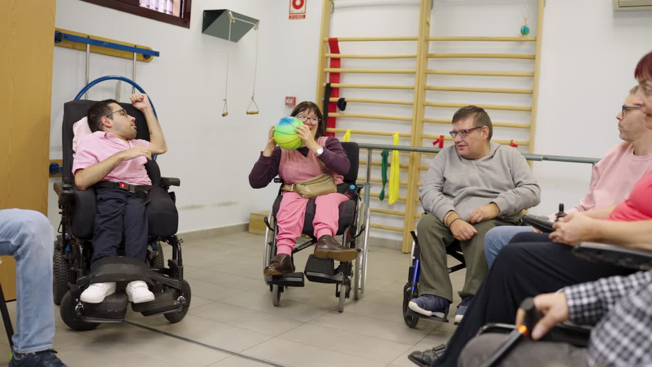Group of People in Wheelchairs Exercising in a Gym