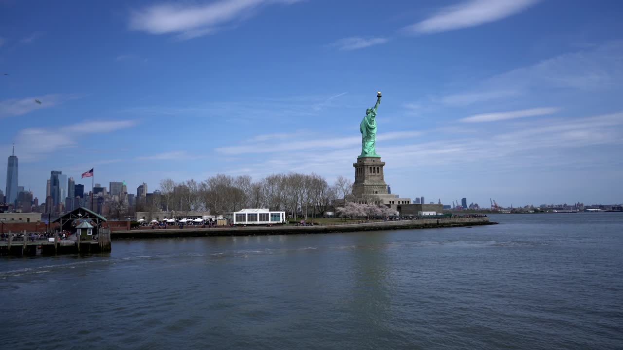 Statue of Liberty on Liberty Island, New York City Skyline in Background, wide