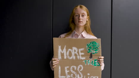 cute redhead holding a placard and protesting