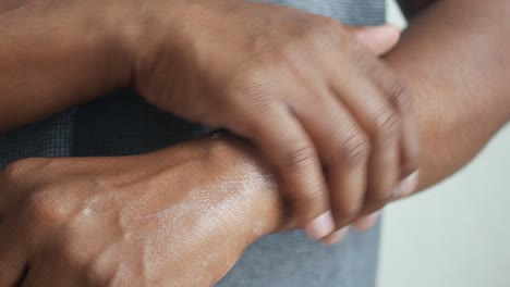 man applying lotion to his arm