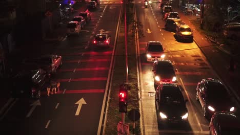 Aerial-View-Of-Street-Traffic-At-Night-In-Town-With-Traffic-Light-Turn-Green-To-Red