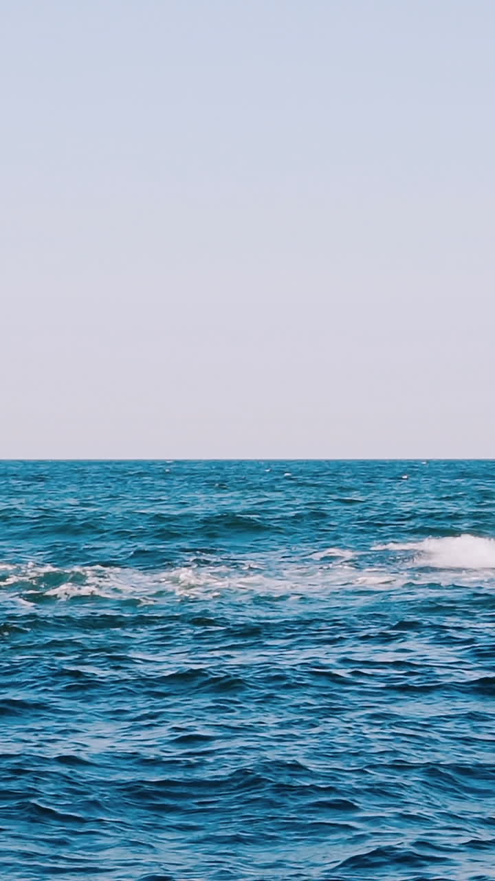 Breaking sea wave. Seascape with wide horizon of the sky and the sea