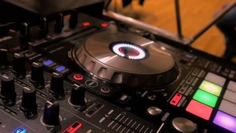 dj playing party music on modern cd usb player, scratching records, nightlife and entertainment concept, handheld close up shot