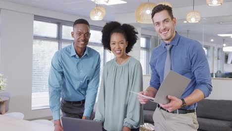 Portrait-of-happy-diverse-business-people-looking-at-camera-and-smiling-at-office,-slow-motion