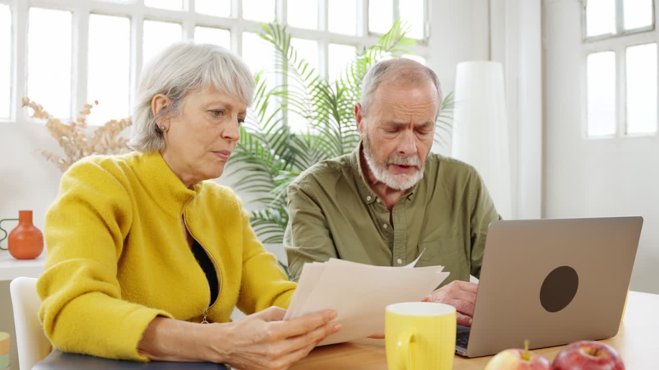 Senior couple managing finances at home