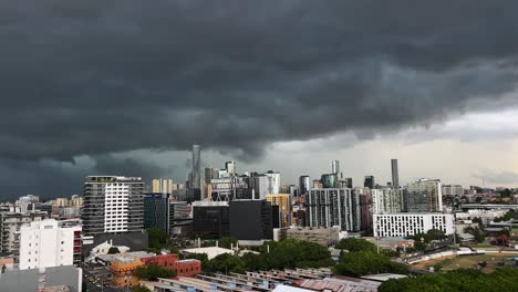 destructive storm, ominous dark clouds covering the whole sky of brisbane city, queensland, handheld motion shot capturing dramatic cumulus nimbus cloud forming in the sky, severe weather forecast