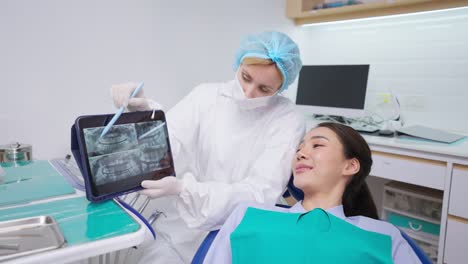 dentist showing x-ray to patient