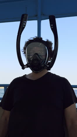 man wearing snorkeling mask on a boat