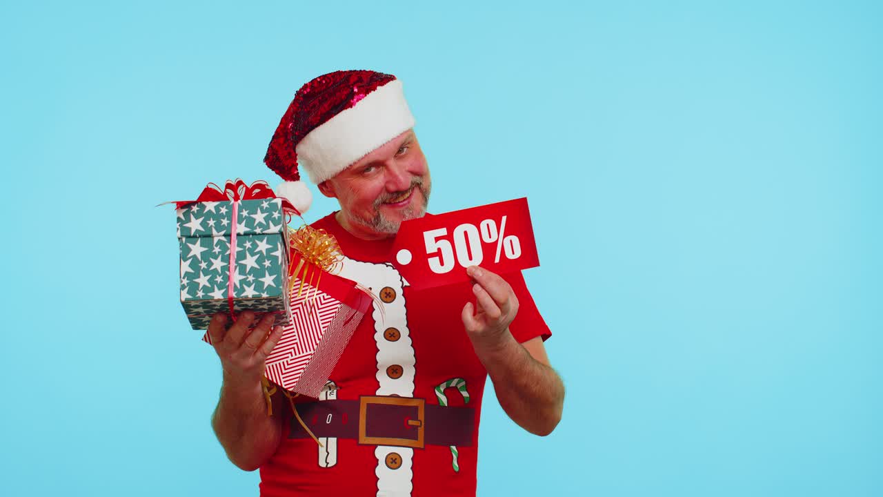 Man in red christmas tshirt showing gift box and 50 percent discount inscriptions banner text note
