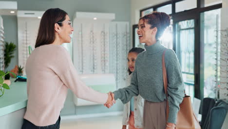 woman and child greeting optician in eye care store