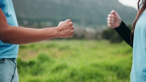 fist bump between volunteers in nature