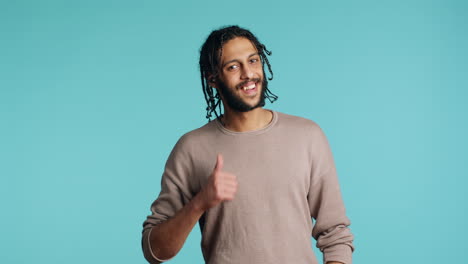 man doing thumbs up hand gesturing, showing approval, having positive mood