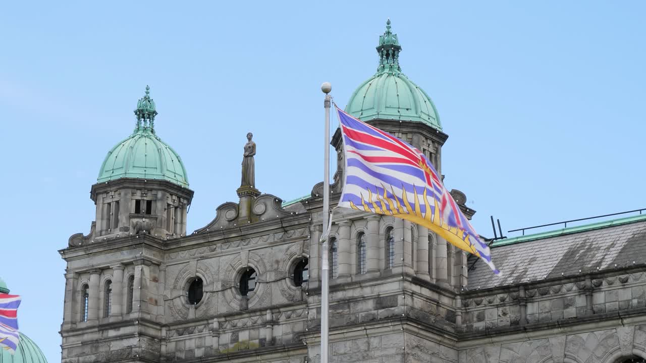 British Columbia Flag and Parliament Buildings in the background,Victoria, Canada.