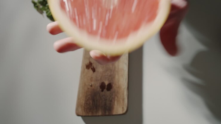 Hand holding a grapefruit in the kitchen