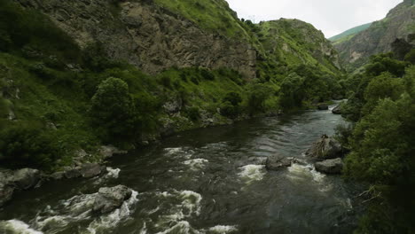 flying through stream of mtkvari river in the mountains of tmogvi fortress in georgia