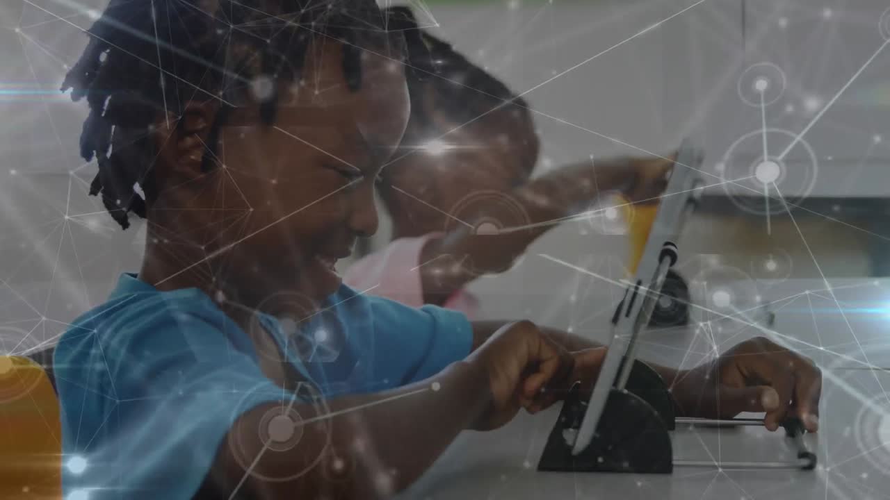 Animation of network of connections over african american boy using digital tablet at school