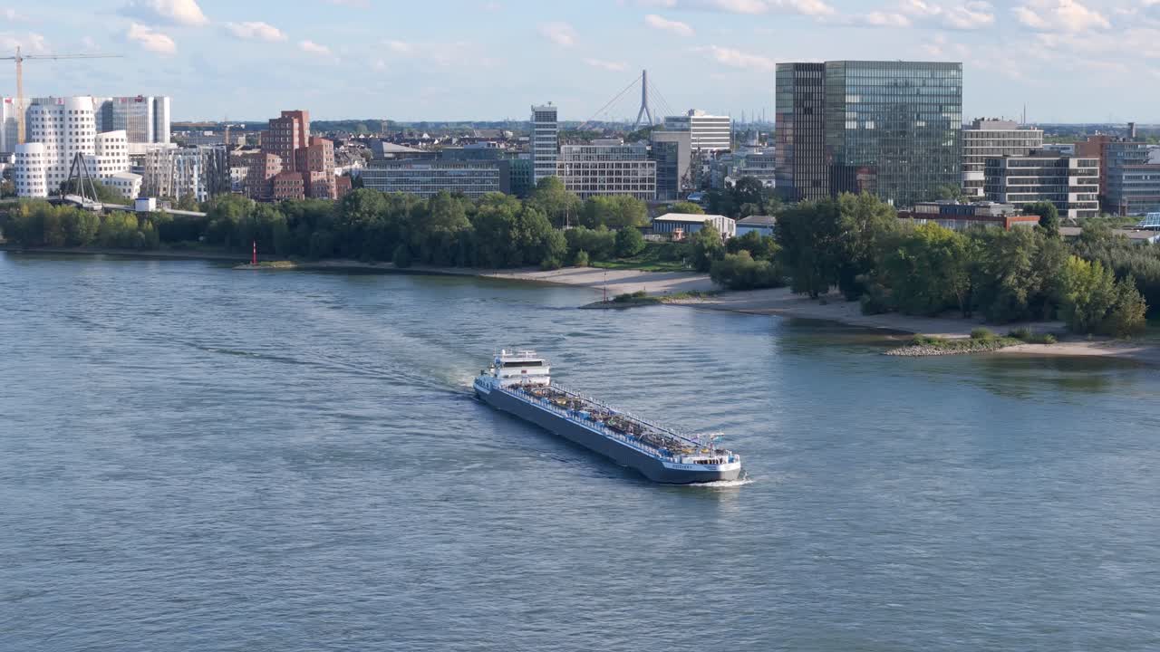 A panorama view of D&uuml;sseldorf and a cargo ship on the Rhine River
