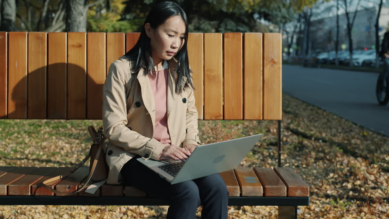 Woman Working on Laptop in Park