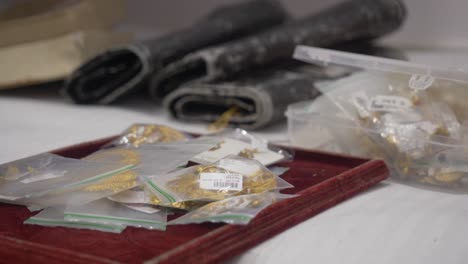 boxed filled with hallmarked gold ornaments with barcode tags at a jewelry shop, selective focus