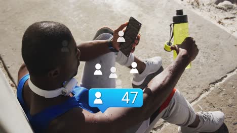Animation-of-people-icons-with-numbers-over-african-american-male-athlete-with-bottle-using-phone