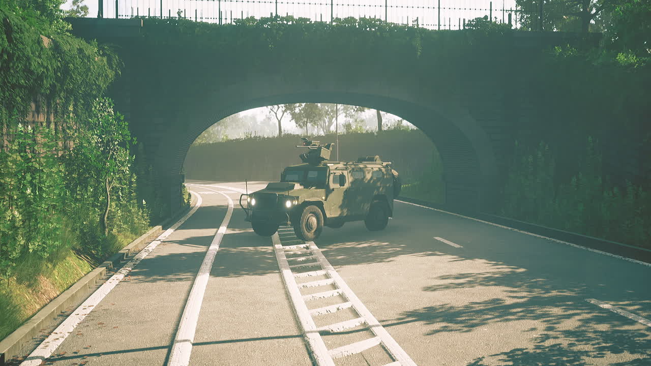 Military vehicle navigates winding road under charming stone arch bridge