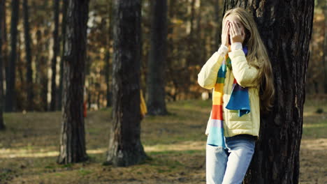 Cute-Caucasian-children-playing-hide-and-seek-in-the-middle-of-the-forest-on-a-sunny-day