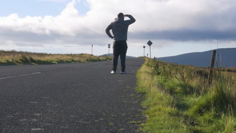 lost man walking on the uphill road, searching and looking for a right way at the wicklow mountains in ireland