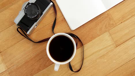 camera with notepad and cup of coffee