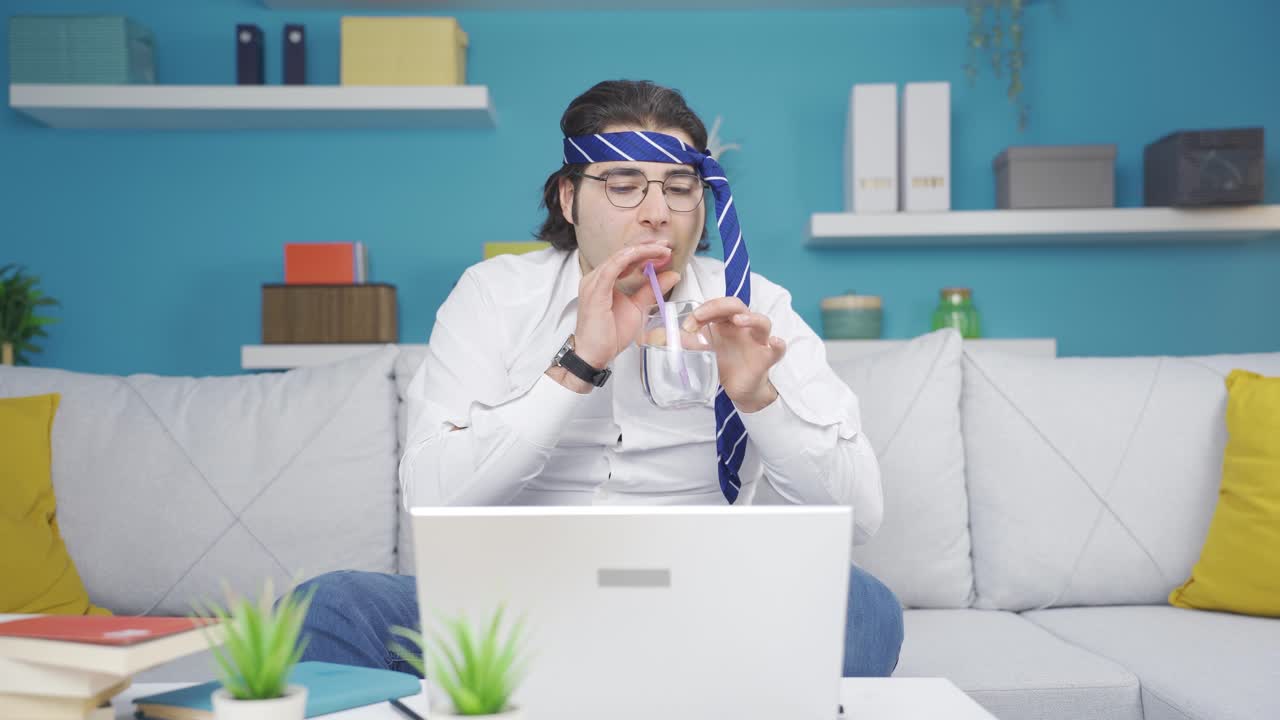 Funny businessman bubbling water in glass at home. It's funny and entertaining.