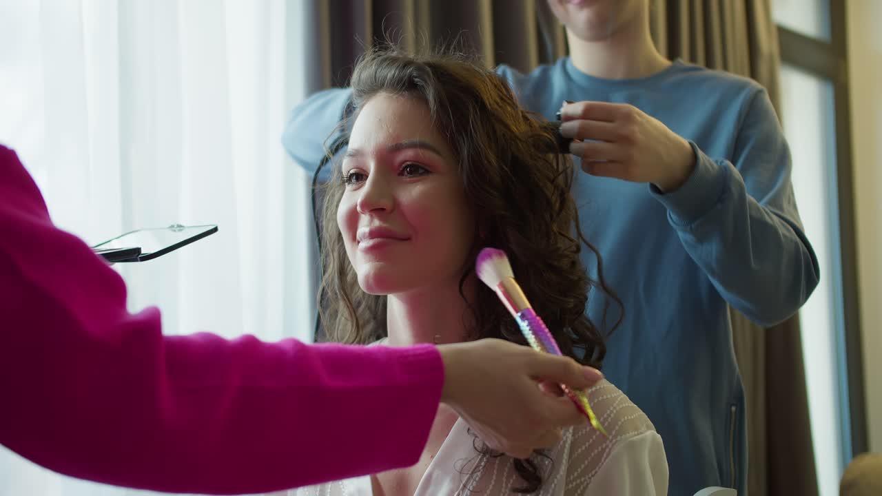 hermosas doncellas están preparando a la novia para la boda en casa, de cerca