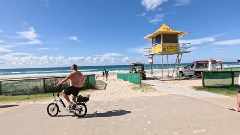 people cycling and walking near a beach