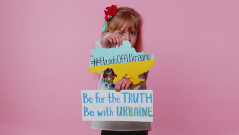 toddler ukrainian girl alone protesting war conflict raises inscription massage hands off ukraine