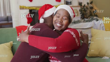 animation of christmas jolly text over senior african american couple in santa hats at christmas