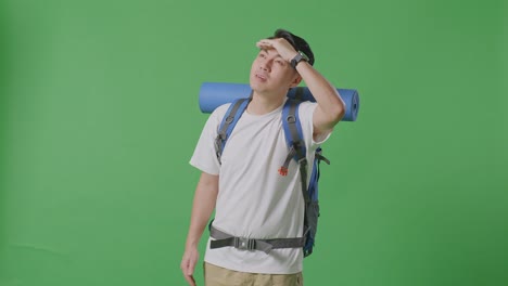 man with a backpack looking up