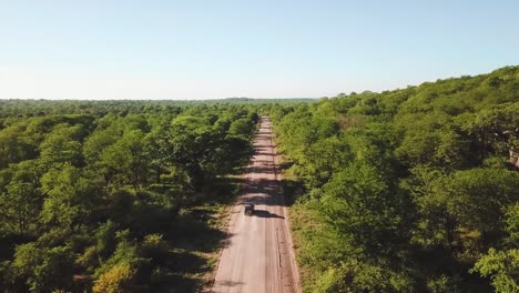 drone view of car travelling in the african landscape revealing the horizon