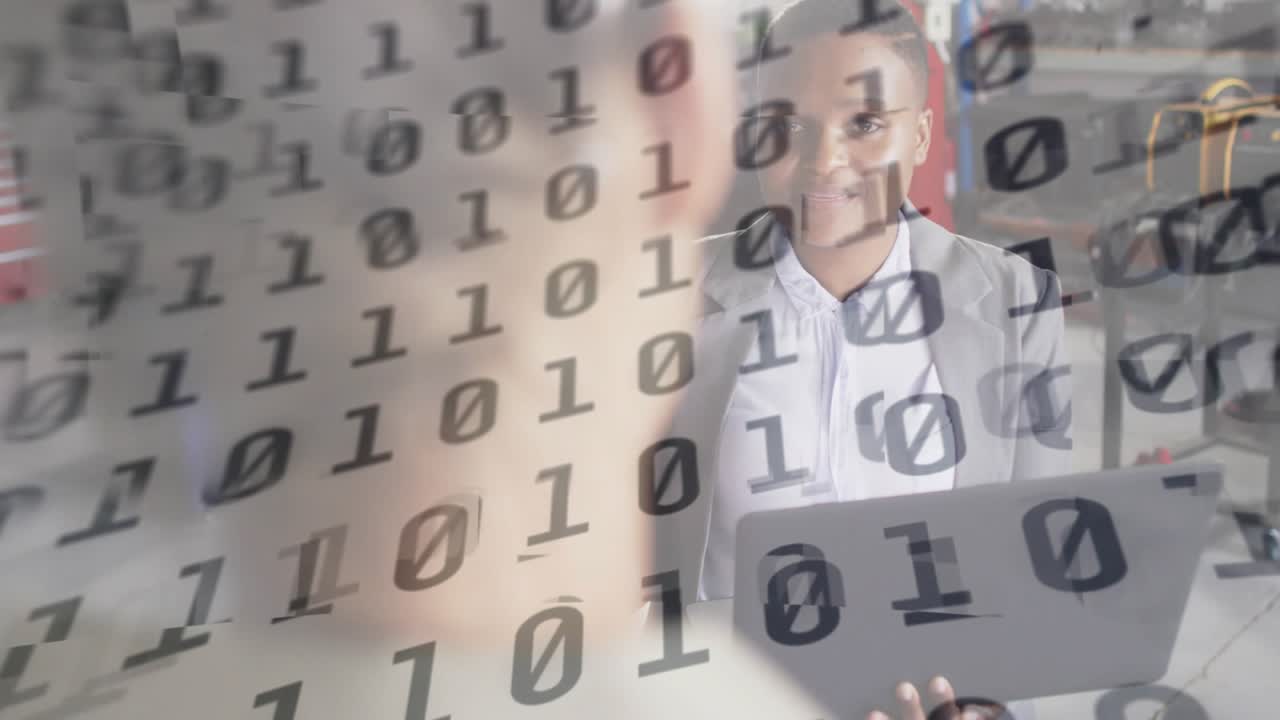 Camera focusing factory presenter pointing toward binary code explaining results typing laptop