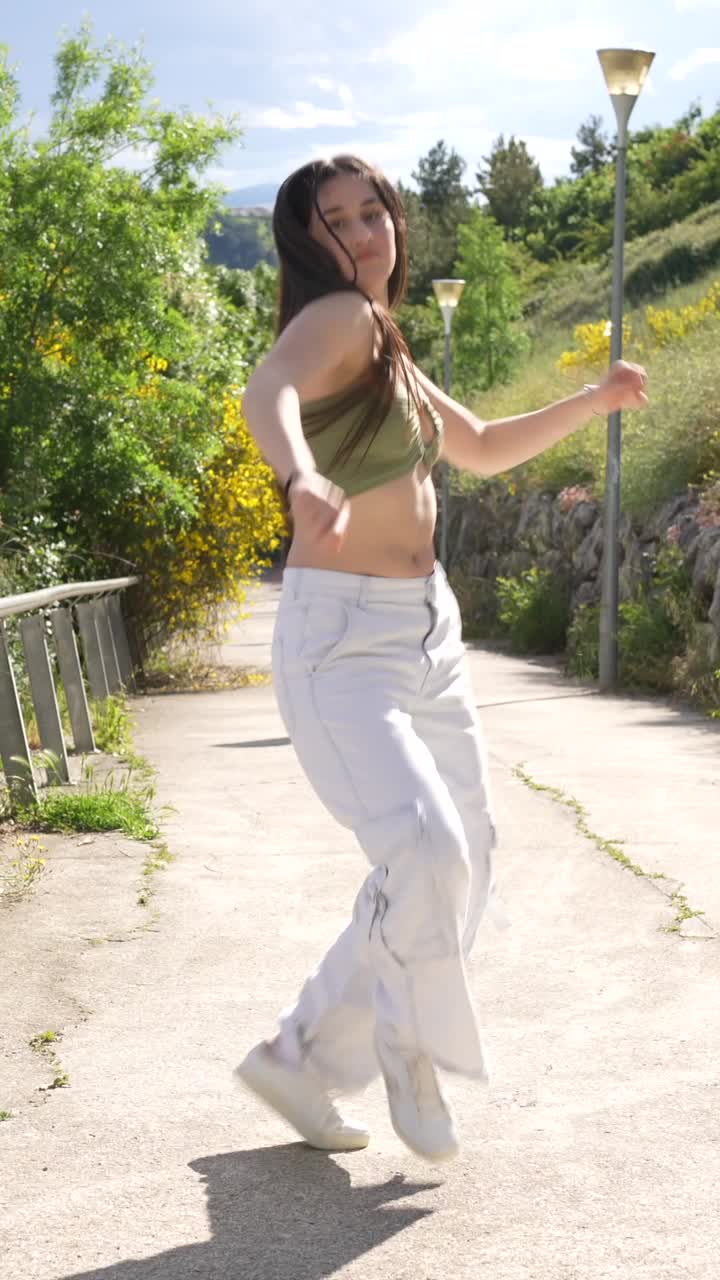 Young Woman Dancing Outdoors in Casual Wear